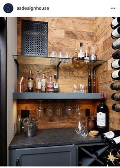 a wine rack filled with lots of bottles and glasses next to a wall mounted shelf