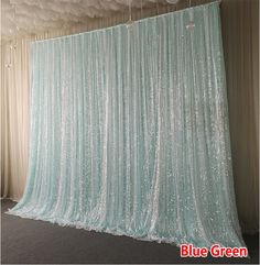 a room that has some curtains on the wall in front of it and carpeted flooring