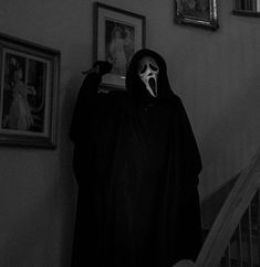 a person in a ghost costume standing on the stairs with their mouth open and tongue out