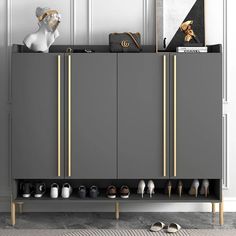 a grey cabinet with gold handles and shoes