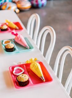 the table is set with cupcakes, muffins and other desserts