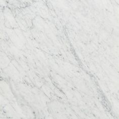 a white marble counter top with grey veiners