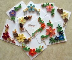 several different colored paper flowers on top of each other