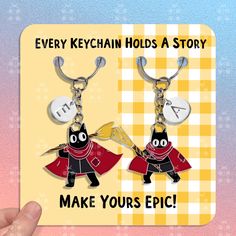 two keychains with the words make yours epic and an image of a black cat