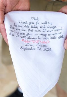 a person holding a handkerchief with a poem written on it