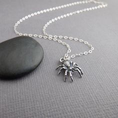 small sterling silver spider necklace, 1/2"  - A sterling silver charm, measuring 1/2" (12 mm) across and down.  - Necklace is solid sterling silver 1.5 mm cable chain, with lobster clasp and locking jump rings, all solid sterling silver. Length customizable at drop down menu. - Oxidizing (blackening) on the charm to bring out the details. - With sustainability in mind, charm is made from 100% post-consumer recycled sterling silver. - Packaged in a modern circular tin, ready for gift giving, and comes with a silver polish pad and care instructions. Customize chain length or "charm only" option: - Charm only option, no chain. Charm does include a top ring. - Chain length: Choose a set length from the drop down menu or choose "Other" and leave a note in the box at checkout. I can do any leng Halloween Symbols, Spider Jewelry, Spider Necklace, Silver Polish, Ring Chain, Top Rings, Halloween Jewelry, Recycled Sterling Silver, Animal Jewelry