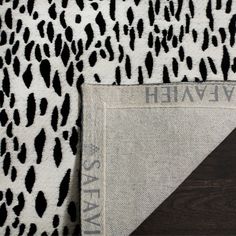 the black and white animal print fabric is next to an area rug that says, we are