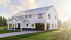 a large white barn style house with two garages