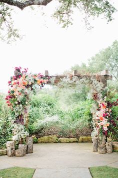 the wedding arch is decorated with flowers and greenery for an outdoor photo shoot on instagram