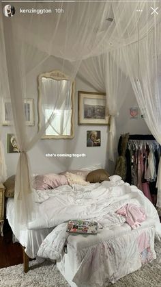 a white bed sitting in a bedroom next to a window