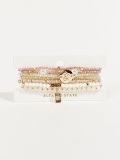 Elevate your accessory game with this set that effortlessly combines charm and adaptability. This pack of layered beaded stretch charm bracelets, offer versatile and stylish wrist accessories for any occasion Altard State Bracelets, Trendy Multi-strand Gold Beaded Bracelets, Trendy Multi-strand Beaded Bracelets, Trendy Gold Multi-strand Beaded Bracelets, Trendy Multi-strand Beaded Bracelets For Gift, Taylor Swift Christmas, Wrist Accessories, Bracelet Pack, Bow Bracelet