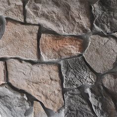 a close up view of a stone wall that has been made from different types of stones