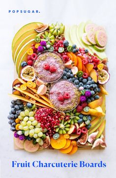 an arrangement of fruits and vegetables on a cutting board