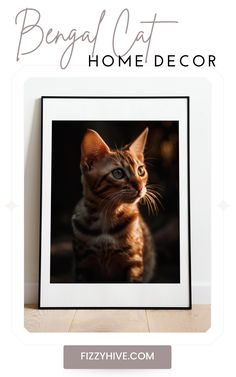 a cat sitting on top of a wooden floor next to a white framed photo with the words bengal cat home decor above it