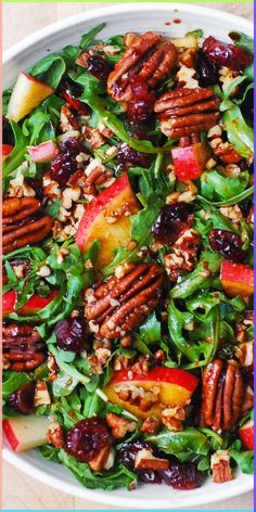 a salad with apples, cranberries and pecans