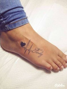 a person with a heart tattoo on their foot