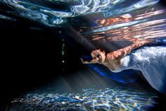 a man swimming under water in the ocean