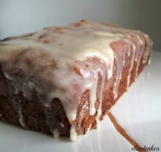 a close up of a piece of cake with icing on a white tablecloth