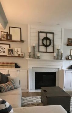 a living room filled with furniture and a fire place in the middle of a room