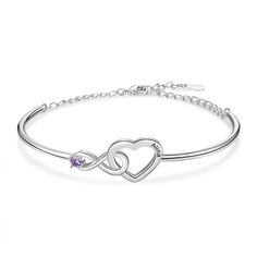 a silver bracelet with two hearts and an amethorate stone in the center