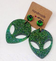 👽 Alien head olographic earrings, Glitter resin green earrings, Sparkly Dangle Earrings, Space Themed Jewellery, Alien Accessories, Glitter Jewellery 👽 👽 I can make a pair especially for you of your favourite color: just drop me a line! 👽 There arrings are made of crystal epoxy resin, glass pigments and glitters. Studs are nickel free, with beautiful faceted crystal. Each pair of these Alien earrings is one of a kind, depending upon how the resin is mixed with glitters and colors and poured Green Pierced Earrings For Party, Green Sparkling Jewelry For Party, Sparkling Green Jewelry For Party, Green Pierced Jewelry For Party, Green Glitter Earrings As A Gift, Green Resin Drop Earrings, Alien Accessories, Alien Earrings, Earrings Space