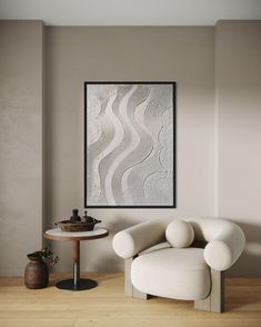 a living room with a white chair and table in front of a painting on the wall