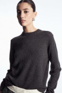 This timeless jumper is a cornerstone of the COS Autumn Winter collections. Offered in a rich dark-brown hue, it's expertly knitted from luxuriously soft 100% cashmere that has been certified by the Good Cashmere Standard, ensuring that it's fully traceable. It's designed with a classic crew neck and neat ribbed trims. Regular fitThe Good Cashmere Standard® is owned by Aid by Trade Foundation(AbTF) and sets out requirements on welfare of cashmere goats, use of natural resources and support of fa Dark Grey Jumper Outfit, Grey Knitwear, Timeless Sweater, Gray Cashmere Sweater, Cashmere Hoodie, Grey Jumper, Cashmere Jumper, Chic Sweaters, Knitwear Men