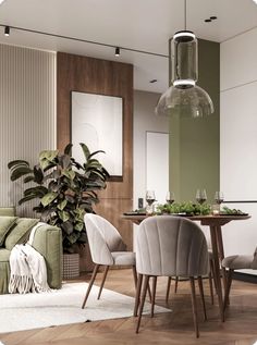 a living room filled with furniture next to a dining table and potted plant on top of a hard wood floor