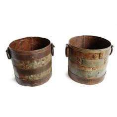 two old metal buckets sitting next to each other