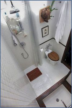 a bathroom with a toilet, sink and shower head in the corner is shown from above