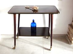 a blue bottle sitting on top of a glass table