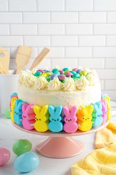 an easter cake with white frosting and colorful decorations