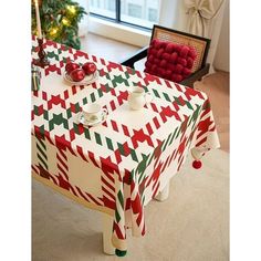 a christmas themed table cloth with red, green and white checkered designs on it