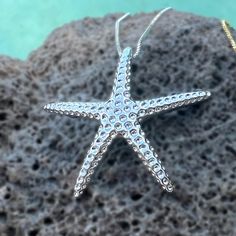 Catch a shooting star with our "Hoku" Starfish Pendant - crafted in .925 Sterling Silver or Gold Plated. Textured to mimic the look of a real starfish, it sparkles when it moves with you. Clever bale design is integrated into the pendant. This special is an 18 inch adjustable chain. "Hoku" Starfish Pendant Textured to mimic the look of a real starfish Clever bale design integrated into pendant Available in .925 Sterling Silver or Gold Plated Special matching 18 inch adjustable chain. Starfish Shaped Jewelry With Star Charm As Gift, Ocean-inspired Star Charm Jewelry, Silver Starfish Charm Jewelry, Sterling Silver Starfish Charm Jewelry, Ocean-inspired Silver Star Jewelry, Ocean-inspired Star Shaped Silver Jewelry, Silver Starfish-shaped Jewelry Gift, Silver Starfish Jewelry For Gifting, Silver Starfish Jewelry For Gifts