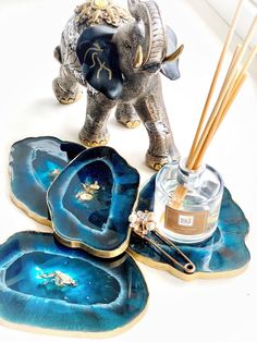 an elephant figurine sitting on top of blue plates