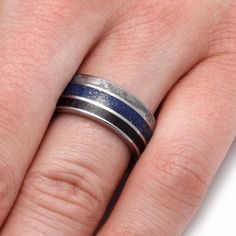 Display your sense of style with my signature dinosaur bone and meteorite ring that also features the stunningly vivid blue lapis lazuli. This style of ring has a timeless quality that will be celebrated for years to come. RING LAYOUTRing Width: 10 mmRing Sleeve: TitaniumRing Profile: Round or FlatRing Finish: Polished 1 mm Titanium2.5 mm Dinosaur Bone0.5 mm Titanium2 mm Lapis Lazuli0.5 mm Titanium2.5 mm Gibeon Meteorite*1 mm Titanium Dinosaur Bone Jewelry, Dinosaur Bone Ring, Gibeon Meteorite, Meteorite Jewelry, Jewelry By Johan, Bone Ring, Inlay Jewelry, Protection Jewelry, Meteorite Ring