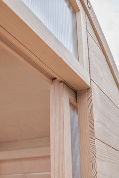 a close up view of the side of a house with wood siding and glass windows