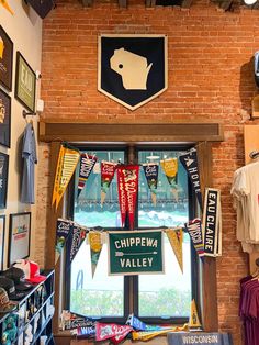 there is a display in the shop with flags and pennants hanging from the windows