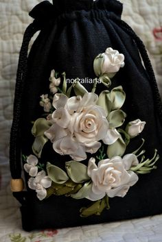 a black bag with white flowers on it