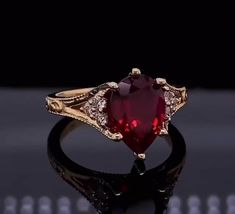 Art Deco 3 CT Red Pear Cut Ruby Diamond Ring, Engagement Ring, 10K 14K 18K Solid White Yellow or Rose Gold Ring Anniversary Gift Ring Bridal Ring ✥ Ring Metal ✥ ✦ Metal : 925 Sterling Silver, 10K 14K 18K Solid White Yellow and Rose Gold ✦ Metal Purity : 100% high Polished ✦ Stamp/ Hallmark : Yes, Indicate inside the Ring   ✥ Center Diamond Detail ✥ ✦ Center Diamond type : Ruby Diamond ✦ Center Diamond Shape : Round Cut Diamond ✦ Center Diamond Weight : 3 CT ✦ Center Diamond Color : Red ✦ Center Diamond Clarity : VVS1 ✦ Make: High-Quality Craftsmanship ✥ Side Diamond Detail ✥ ✦ Side Diamond type : Moissanite Diamond ✦ Side Diamond Shape : Round  Cut Diamond ✦ Side Diamond Weight : 0.52 CT ✦ Side Diamond Color : White ✦ Side Diamond Clarity : VVS1 ✦ Make: High-Quality Craftsmanship ✥ Ring Us Ruby Engagement Ring Gold, Red Diamond Ring, Ruby Engagement Ring Vintage, Pear Cut Diamond Ring, Ruby Wedding Rings, Ruby Diamond Ring, Luxury Jewelry Box, Red Pear, Diamond Ring Engagement