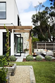 an outdoor living area with couches and tables