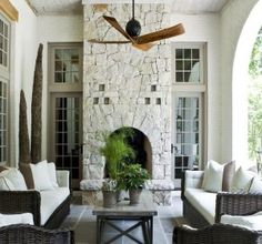 a living room filled with furniture and a ceiling fan