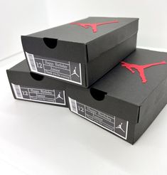 two black boxes with red air jordan logo on the front and bottom, sitting side by side