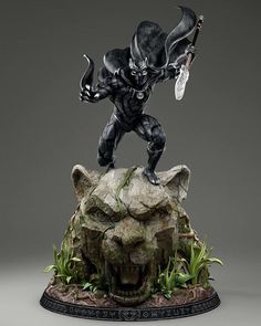 a statue of a black panther on top of a rock