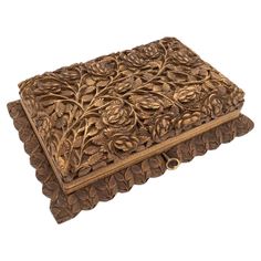 a decorative wooden box with flowers and leaves