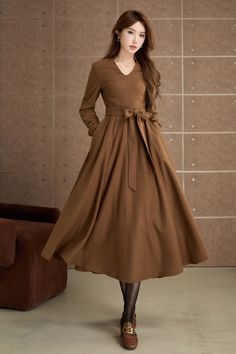 Step into timeless elegance with this vintage-inspired brown dress. Crafted from a smooth, woolen fabric, this mid-length dress features a flattering V-neckline and long sleeves. The flared skirt adds a touch of femininity and movement, making it ideal for both casual outings and special occasions. DETAIL * 30% wool, 30% fiber, 40% polyester * fully satiny lining, more nice to the touch body * Long sleeves dress * Fit and flare dress * Right zipper closure * Two side seam pockets * Belted dress * Mid-calf length dress * Vintage wool dress * Perfect for autumn, winter * Lean More about the items From the FAQs on the page bottom MODEL SIZE Bust 85 cm(33.4") Waist 67 cm(26.7") Height 168cm (5' 6") She wears size XS Choose CUSTOM Order if you * Need a better fit * Can't find your size in our s Midi Dress A Line, Long Sleeves Dress, Calf Length Dress, Dress Autumn, Dress Long Sleeves, Sleeves Dress, Winter Dress, Mid Dresses, Mid Length Dresses