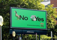 there is a large billboard on the side of the street that says no oyes