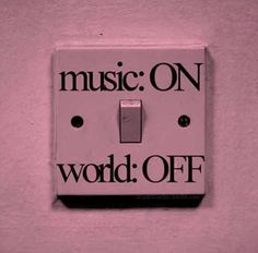 a pink light switch cover with the words music on world off written in black and white