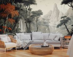 a living room filled with furniture next to a forest wallpaper covered in birds and trees