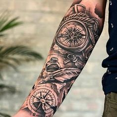 a man's arm with a clock and compass tattoo on it